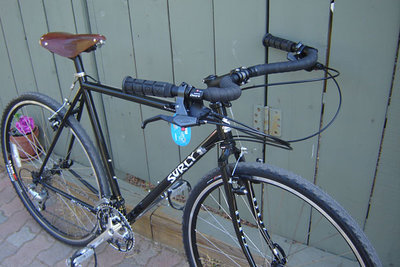 A nice looking Surly Cross Check in black with brown Brooks B-17 saddle
