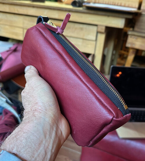 A dopp kit in maroon leather