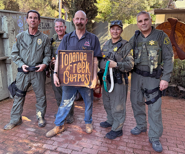 County sheriff in a group showing off their new belts