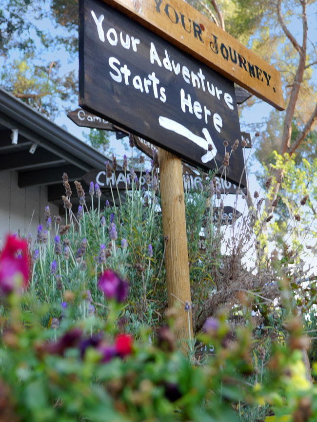 Our shop sign: Your Adventure Starts Here