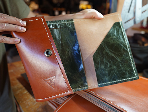 Leather folio for Sophy Hotel unfolded to show the inside pockets