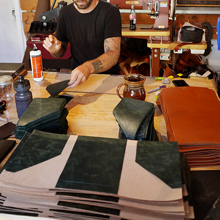 Leathersmith assembling the leather folio for Sophy Hotel Hyde Park