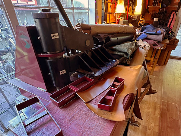 An eight-ton press with die cuts and leather on the press table