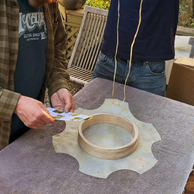 Person making a hand drum out of goat parchment