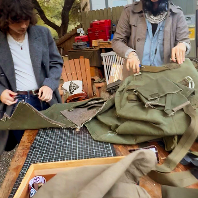 Two guys working with vintage and army surplus materials