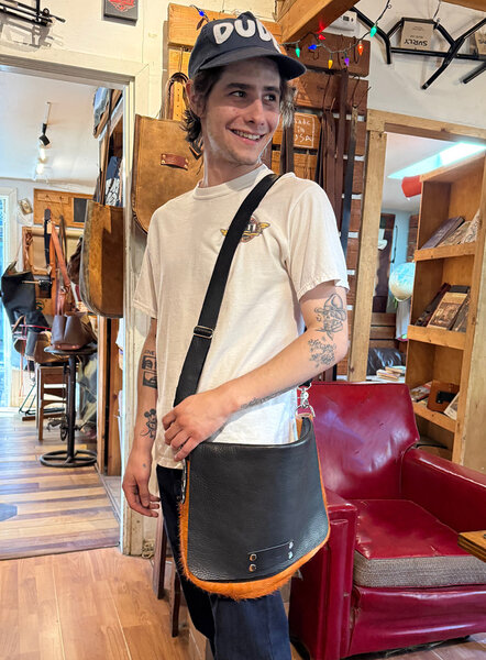 Guy in Dude hat models the custom shoulder bag he just made in our Shoulder Bag Workshop