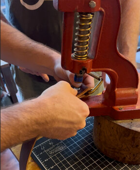A little elbow grease is needed to press rivets onto the belt