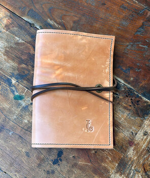 Leather journal cover with TCO logo on the cover