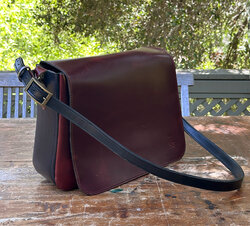 A shoulder bag in premium pull-up leather with an adjustable strap
