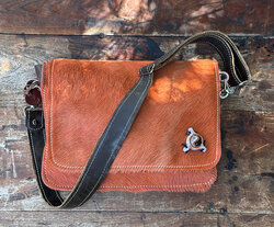 A super unique shoulder bag in orange hair-on-hide