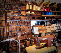 A wall of tools and spools of thead, and Bonnie the leather sewing machine in our crafting studio