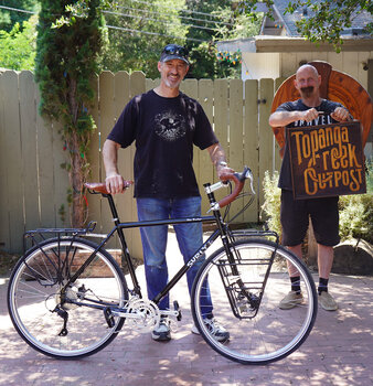 Functional and classy add-ons for this Disc Trucker - Surly front and rear racks, paired with Brooks saddle and bar tape