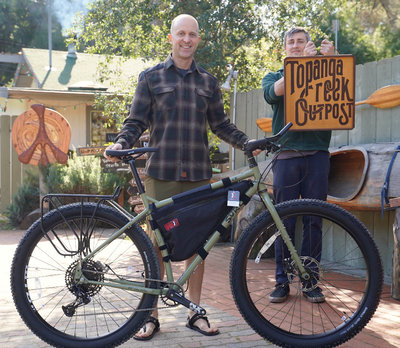 Jimmy's ultimate touring rig the Tank Green Surly ECR has a rear rack and a frame bag for added versatility
