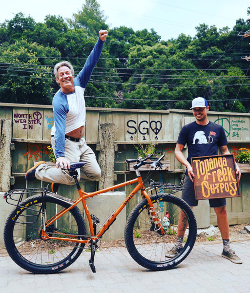 Richard is jumping for joy for his custom Surly ECR that's customized with SON dynamo hub with charging port, Rohloff hub with internal gears, Cane Creek Thudbuster seatpost, Brooks saddle and more