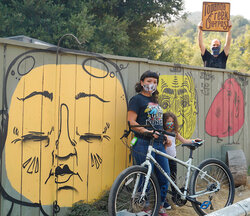 Surly Troll posing in front of the shop's fence of faces before going to a new home