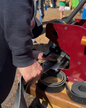 Cutting and trimming the belts after being custom fitted for each fireman and first responder