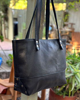 Black leather tote bag pairs well with just about any outfit