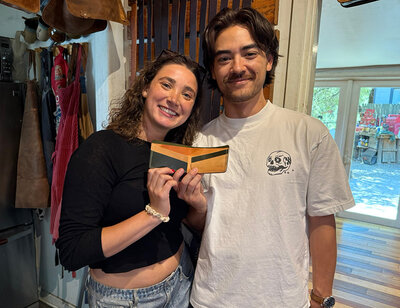 Customer showing off the handcrafted wallet made in our wallet making workshop