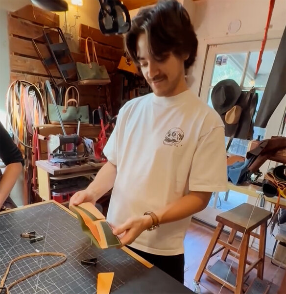 Customer admiring the wallet he made in our wallet workshop